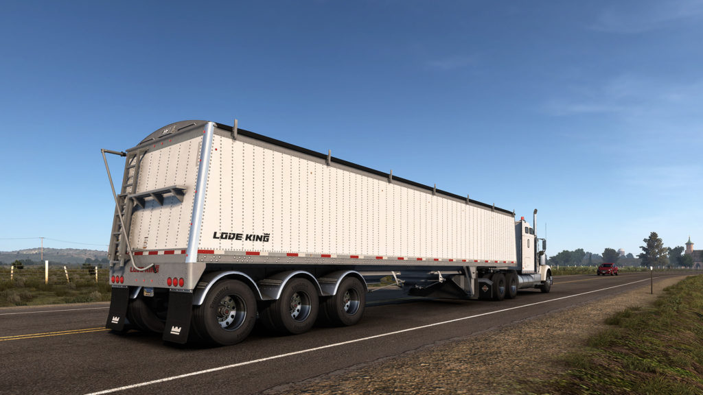 Screenshot of a Distinction trailer being pulled down the road in American Truck Simulator